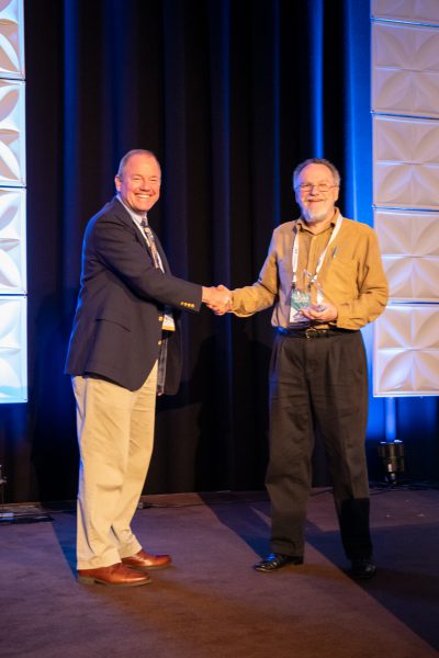 2019 CEC Innovation Award -- Gerald Burnette accepts the award from Paul Tomiczek III, Chief Technology Officer, on behalf of Burnette, Kevin Blackburn, and Chris Sliger