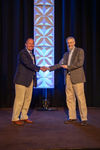 2019 CEC Innovation Award -- Steve Casey accepts the award from Paul Tomiczek III, Chief Technology Officer, on behalf of Mark Janssen and Matthew Skelton